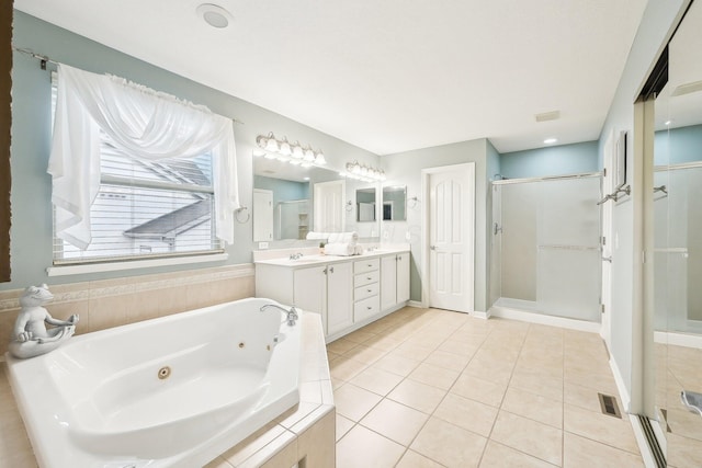 bathroom featuring double vanity, a whirlpool tub, tile patterned flooring, a shower stall, and a sink