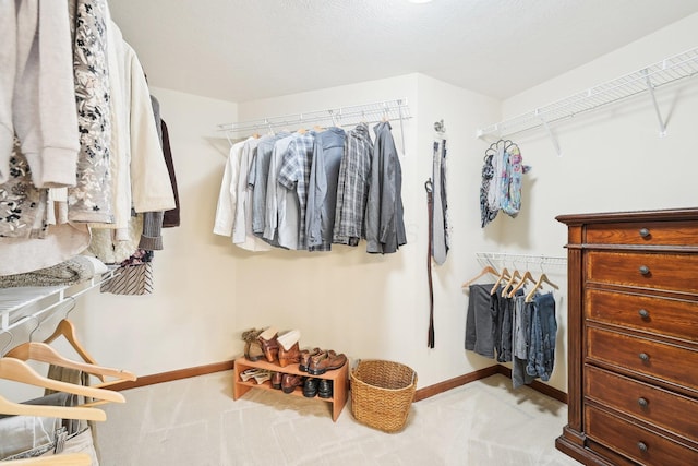 walk in closet featuring carpet floors