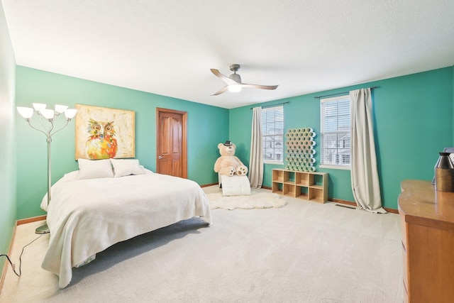 bedroom with carpet, baseboards, and ceiling fan