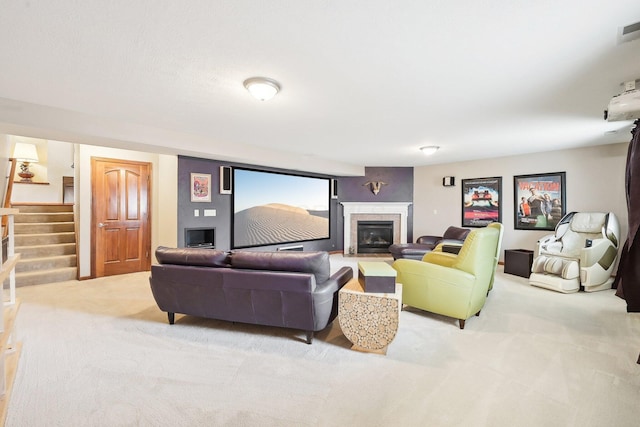 carpeted living area featuring stairs, visible vents, and a tiled fireplace