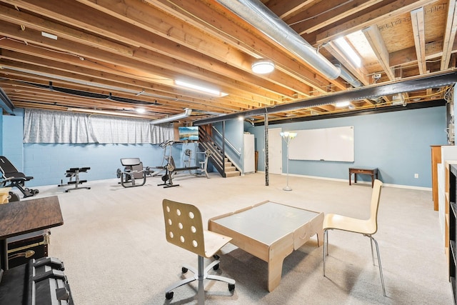 unfinished below grade area featuring stairs, carpet, and baseboards