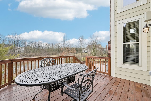 wooden terrace with outdoor dining area