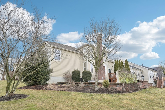 view of property exterior featuring a yard and a chimney