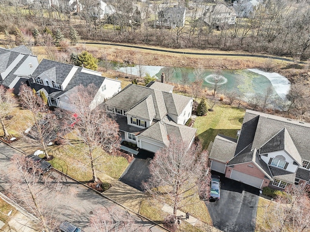 birds eye view of property with a residential view and a water view