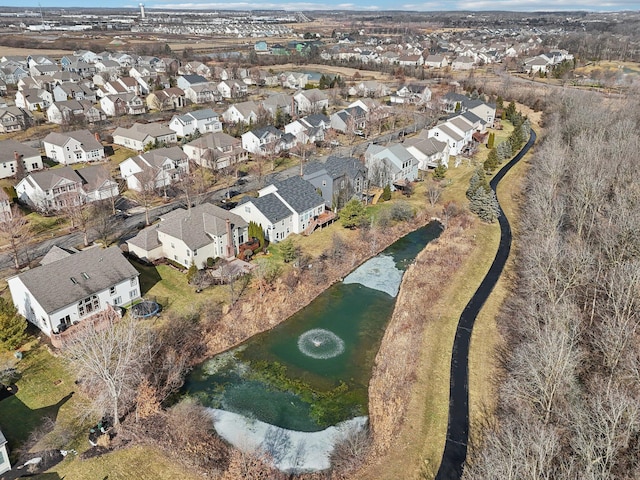 birds eye view of property with a water view and a residential view