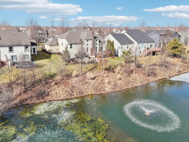 drone / aerial view with a water view and a residential view