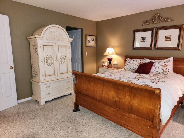 bedroom featuring baseboards and light colored carpet