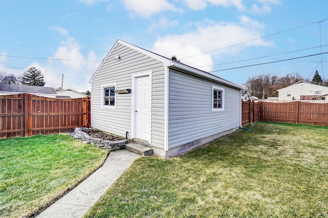 view of outdoor structure featuring an outbuilding and a fenced backyard