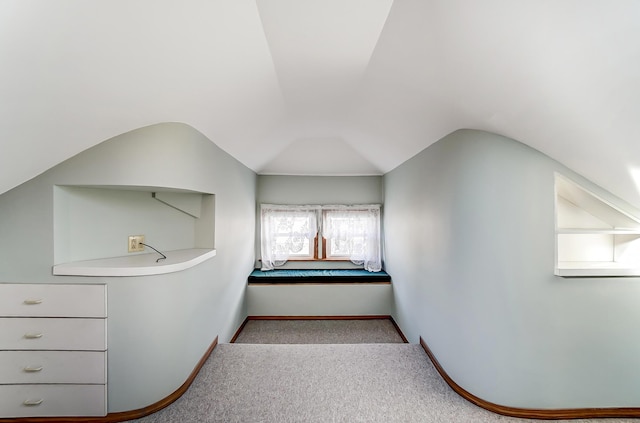 bathroom featuring lofted ceiling and baseboards