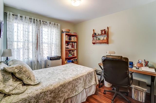 bedroom featuring dark wood-style flooring