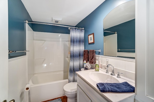 bathroom featuring shower / tub combo with curtain, vanity, and toilet