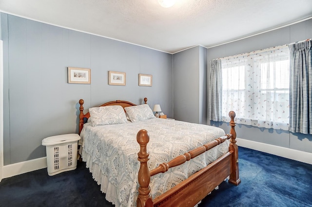 bedroom featuring carpet, baseboards, and a textured ceiling