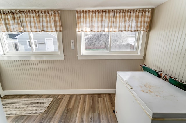 interior space featuring baseboards and wood finished floors