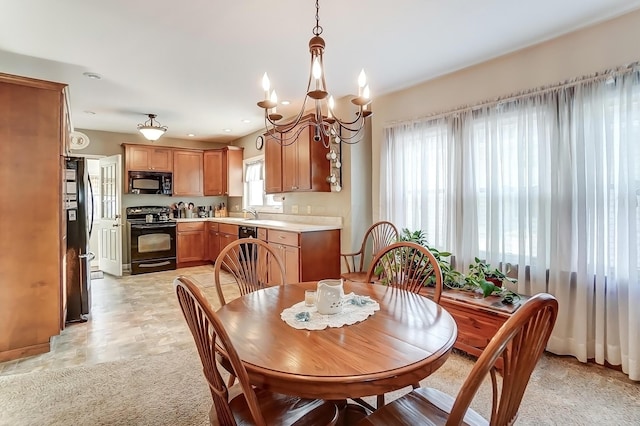 dining space featuring recessed lighting, a chandelier, and light colored carpet