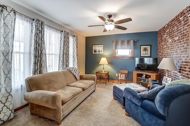 living room with carpet flooring, ceiling fan, and baseboards