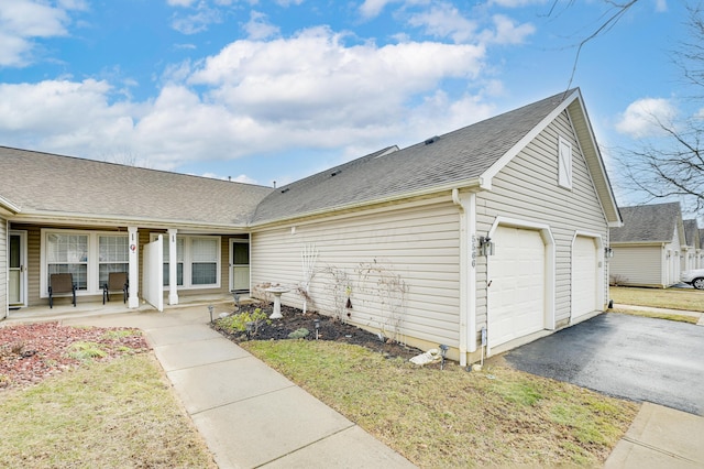 view of front of house with driveway, covered porch, and a shingled roof