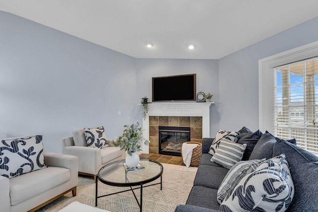 living area with a tile fireplace and recessed lighting