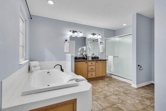 full bathroom with a shower stall, vanity, tile patterned flooring, baseboards, and a bath