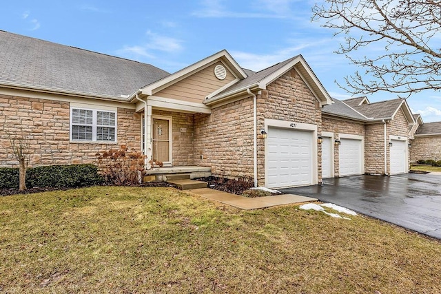 ranch-style house with a garage, a shingled roof, stone siding, aphalt driveway, and a front yard