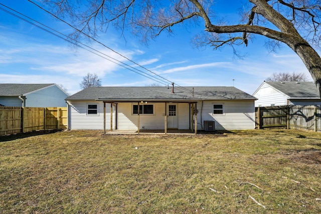 rear view of property with a yard and a fenced backyard