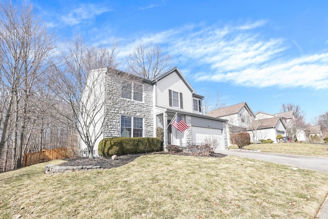 traditional home featuring a garage, driveway, stone siding, and a front yard