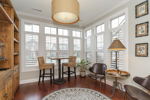 sitting room featuring baseboards, visible vents, dark wood finished floors, and crown molding