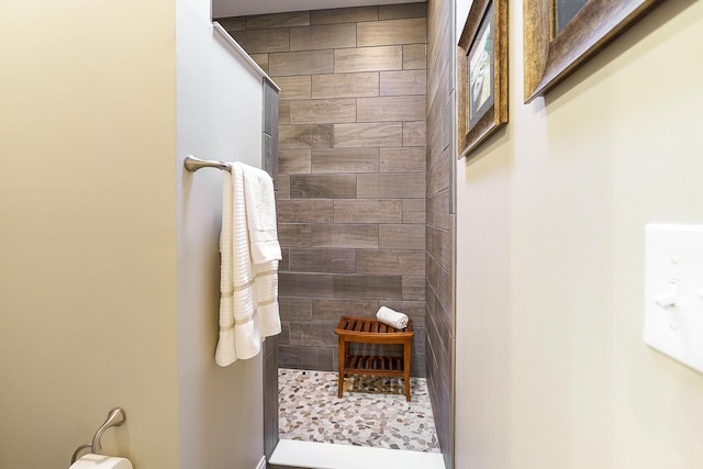 bathroom with a tile shower