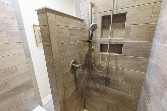 full bath with a tile shower