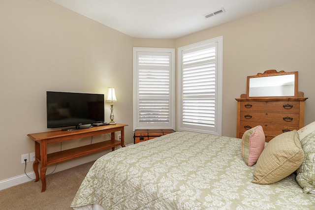 bedroom featuring baseboards, visible vents, and carpet flooring