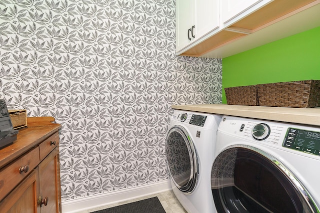 laundry area with washer and clothes dryer, cabinet space, and tile patterned floors