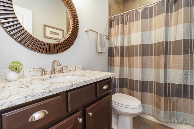 full bathroom featuring toilet, vanity, and a shower with curtain