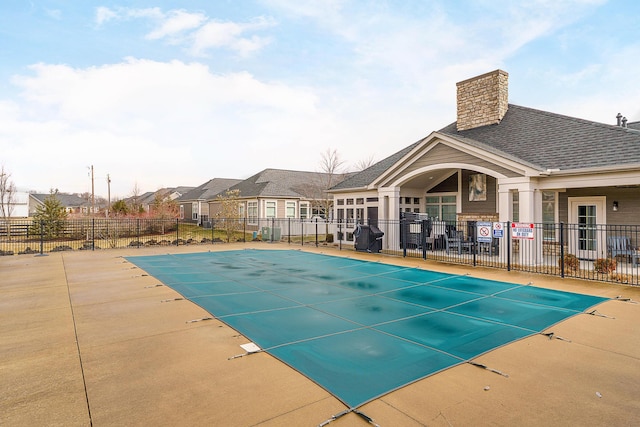 pool featuring area for grilling, a patio area, and fence