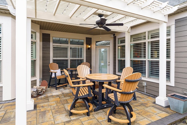 view of patio with ceiling fan, outdoor dining area, and a pergola