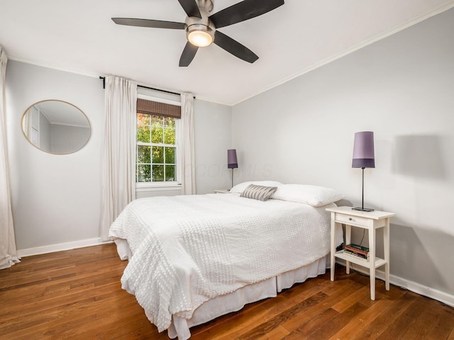 bedroom with baseboards, a ceiling fan, hardwood / wood-style flooring, and crown molding