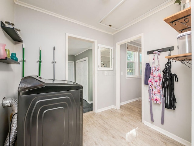 washroom featuring laundry area, baseboards, ornamental molding, independent washer and dryer, and light wood-type flooring