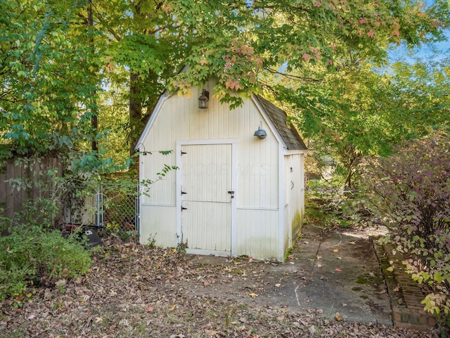 view of shed featuring fence