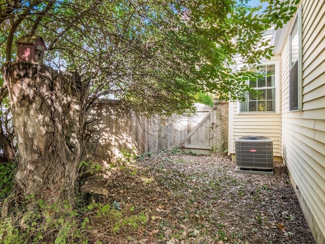 view of yard with fence and cooling unit