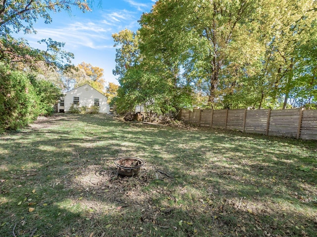 view of yard with an outdoor fire pit and fence