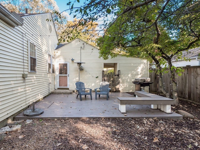 exterior space featuring fence, a deck, and grilling area