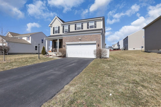 traditional-style house featuring aphalt driveway, a front yard, brick siding, and an attached garage