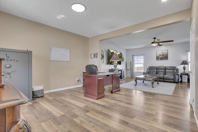 office space featuring light wood-style flooring, baseboards, and ceiling fan