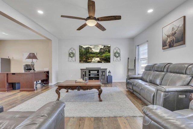 living area with a ceiling fan, recessed lighting, baseboards, and wood finished floors