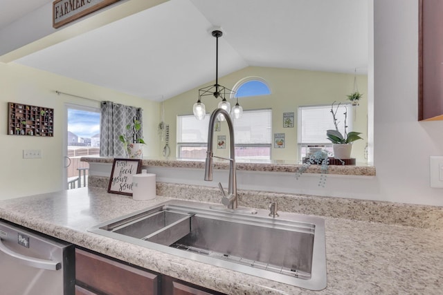 kitchen with vaulted ceiling, stainless steel dishwasher, a sink, and a wealth of natural light