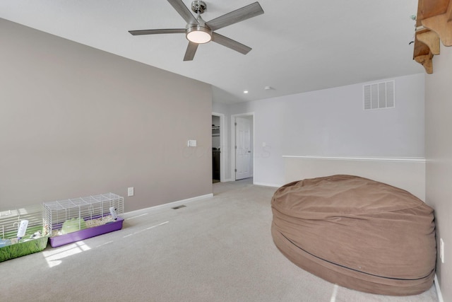 sitting room featuring visible vents, ceiling fan, light carpet, and baseboards