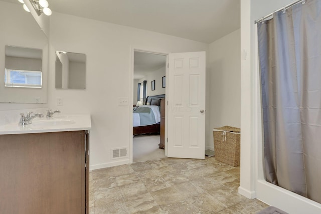 full bath featuring a stall shower, baseboards, visible vents, ensuite bathroom, and vanity