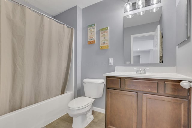 full bath featuring toilet, shower / bath combo with shower curtain, vanity, wood finished floors, and baseboards