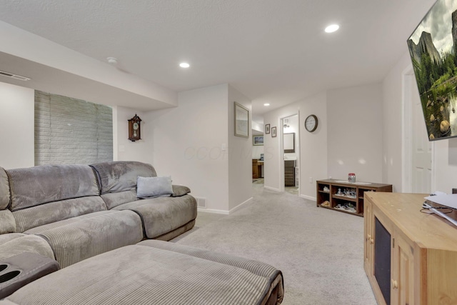 living area featuring light colored carpet, visible vents, baseboards, and recessed lighting