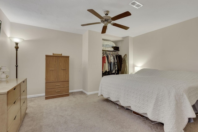 bedroom featuring light carpet, a ceiling fan, visible vents, baseboards, and a closet