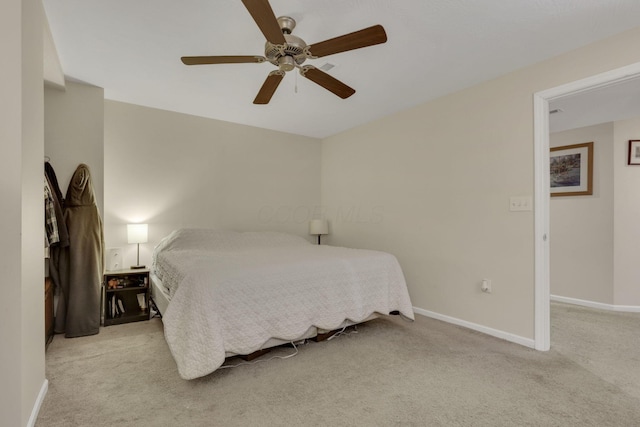 bedroom with light colored carpet, ceiling fan, and baseboards