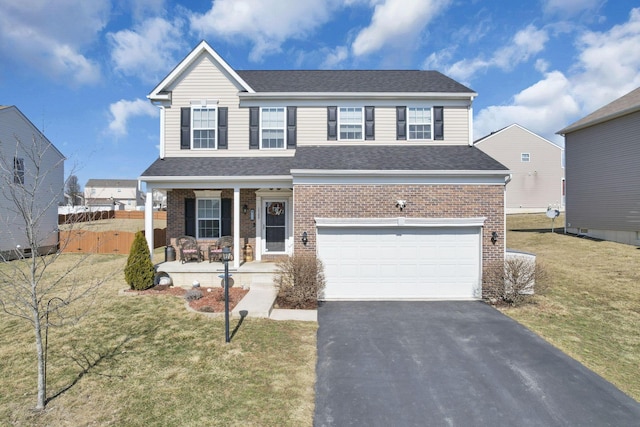 traditional home with aphalt driveway, an attached garage, covered porch, fence, and a front lawn